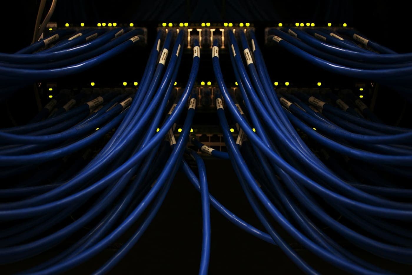 Blue network cables plugged in, glowing in the dark